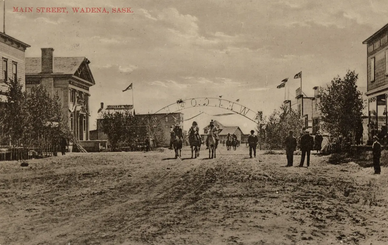 Main Street, Wadena, with welcome arch and riders on horseback, about 1910